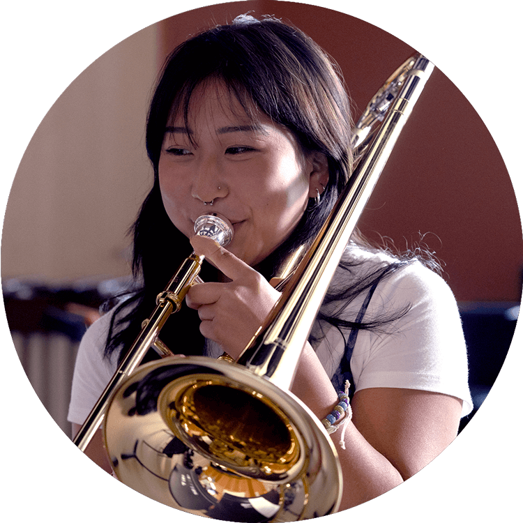 Image of a young girl playing Yamaha instrument Trombone